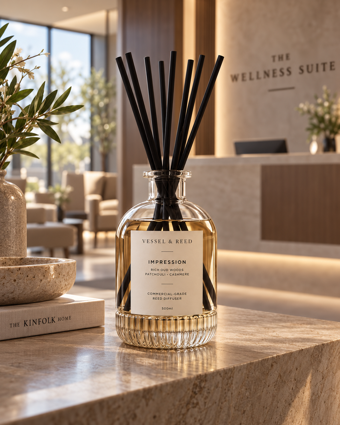 The Vessel & Reed Impression diffuser — fluted glass vessel with black fibre reeds — in a wellness suite reception